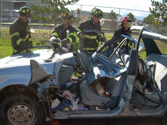 Firefighters reviewing a car crash